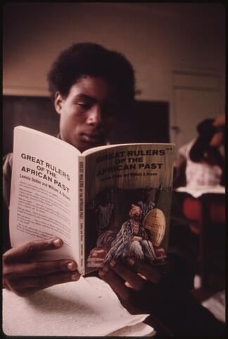 Black student in a Black studies class in a West Side Chicago classroom reading... Black student in a Black studies class in a West Side Chicago classroom reading...